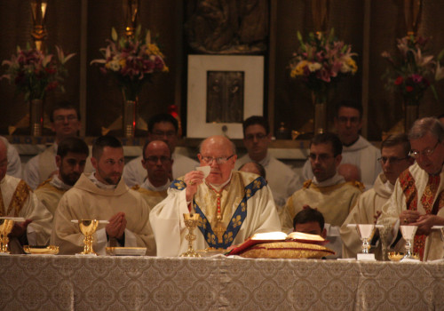 Cardinal Levada celebrates Mass. "Behold the Lamb of God."