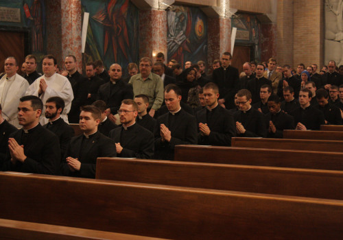 The newly-installed lectors kneel to receive a blessing over their ministry in the Church.