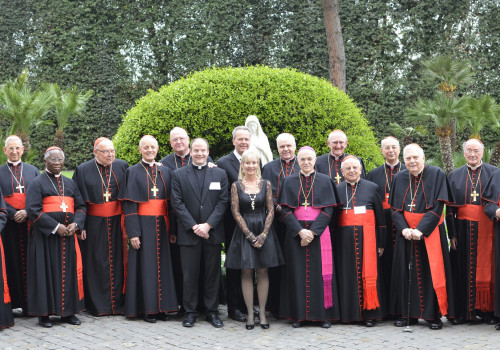 Honorees Tim and Steph Busch and Archbishop Viganò meet for a photo with Very Rev. Peter Harman and all Their Eminences present at the Dinner.