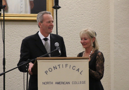Rector's Award honorees Tim and Steph Busch make some remarks at the dinner after accepting the award.